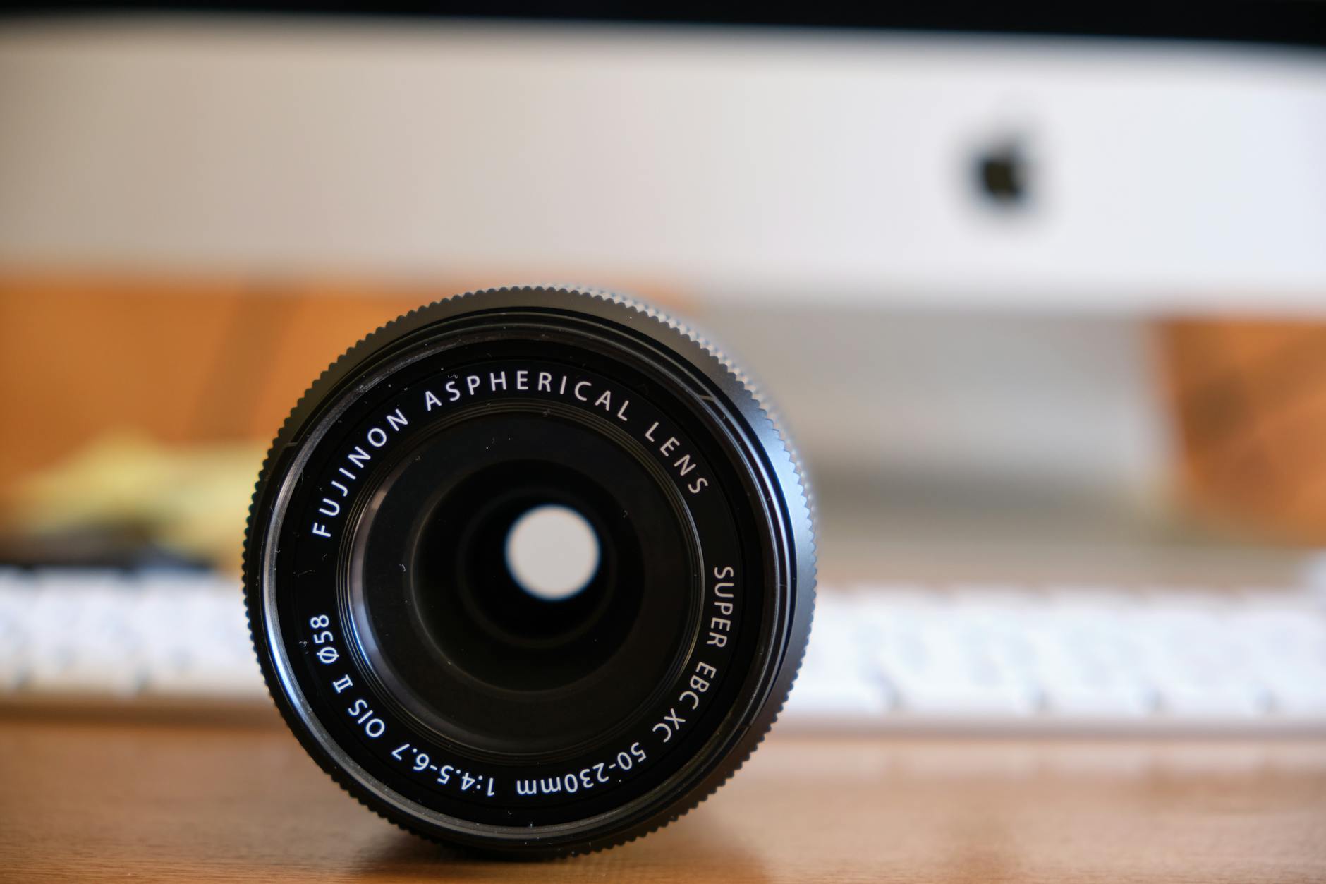 black camera lens on brown wooden table