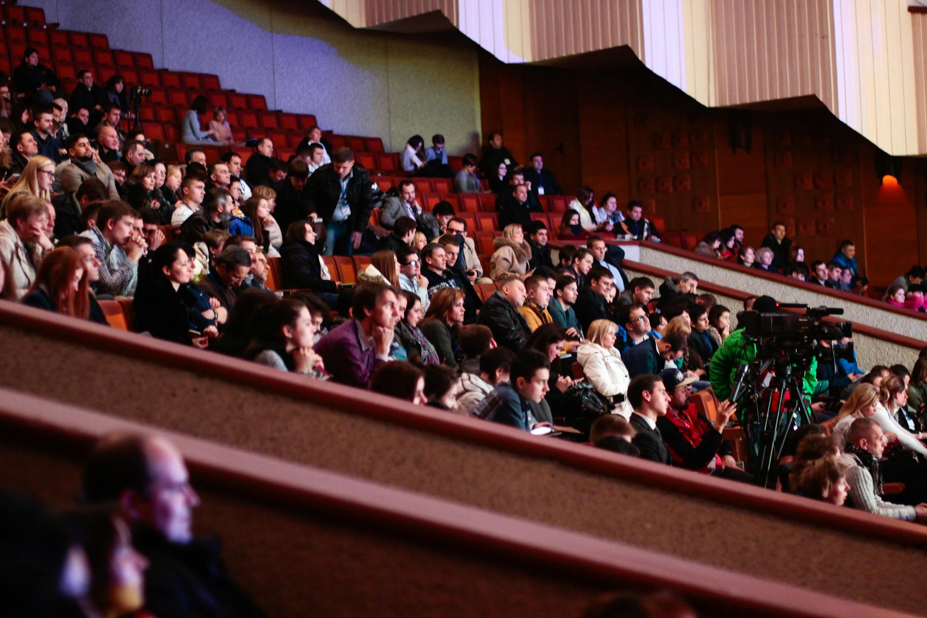 people sitting watching in the theater