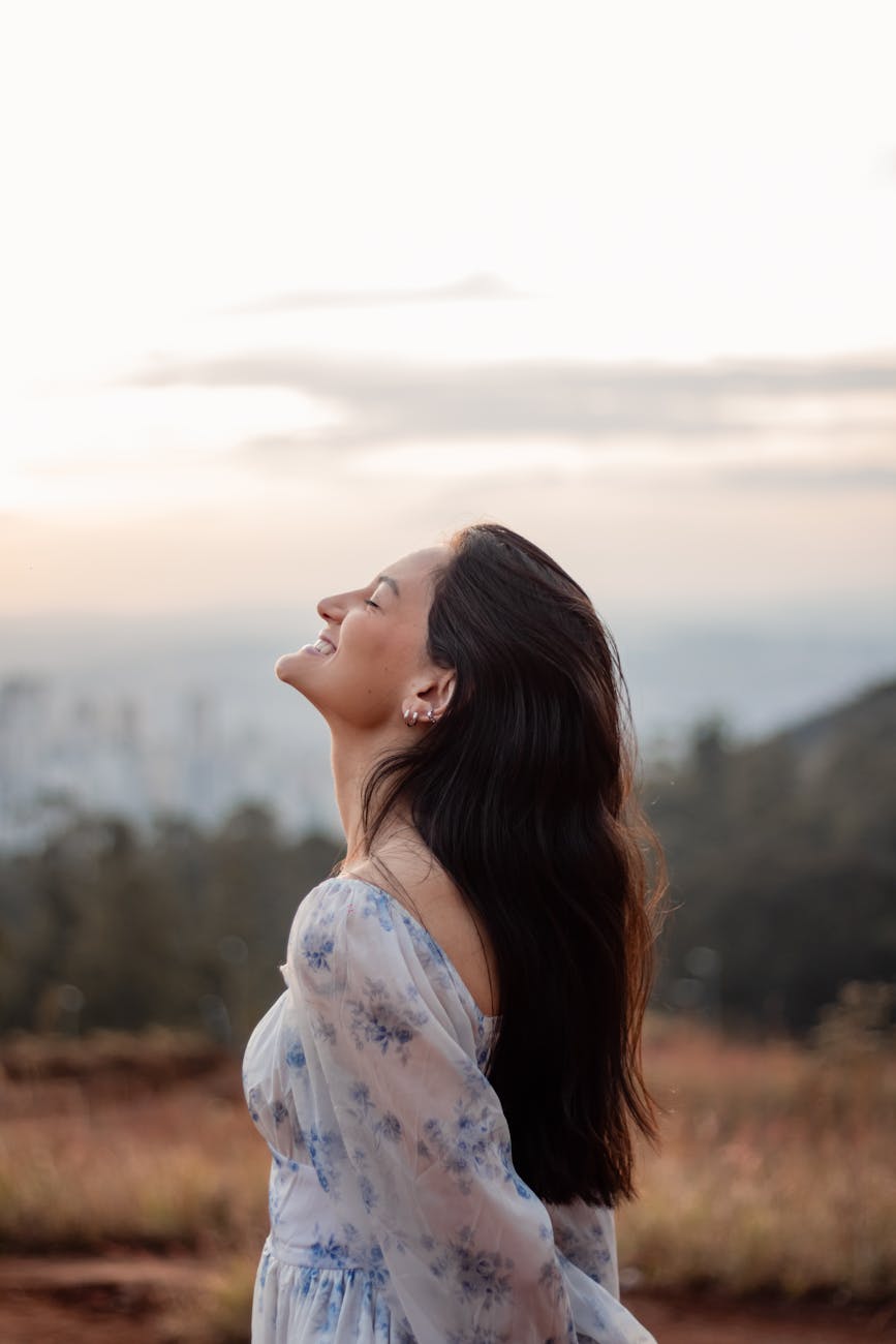 profile of a woman relaxing outdoors at sunset