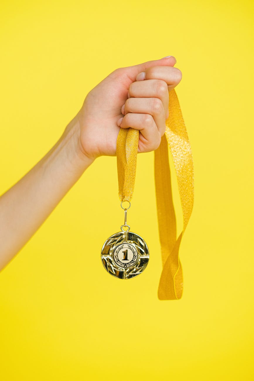 person holding a gold medal