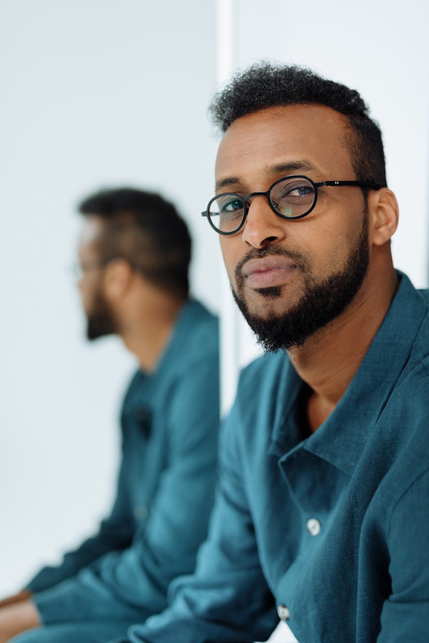 a portrait of a man in black eyeglasses