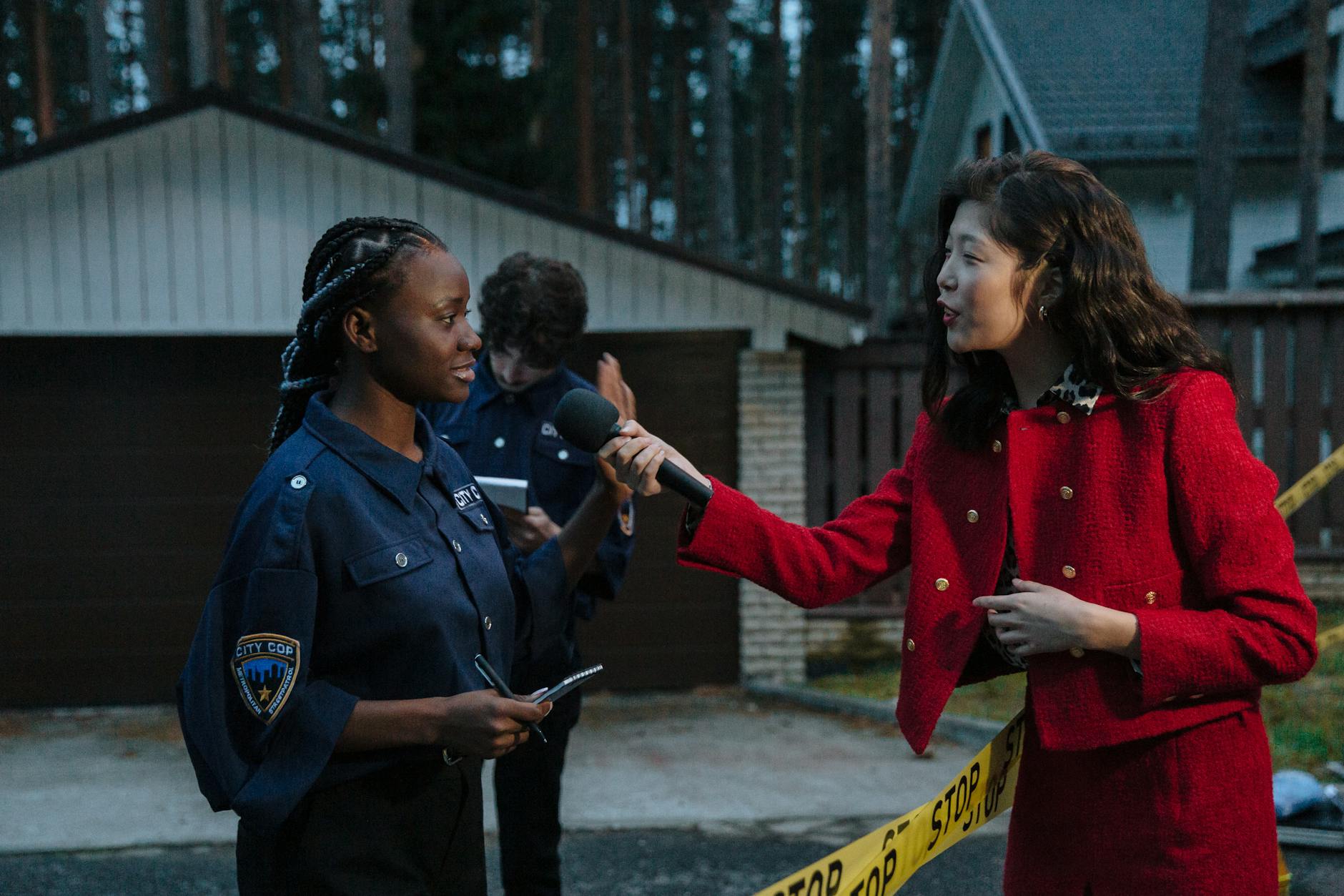 reporter at crime scene interviewing policewoman