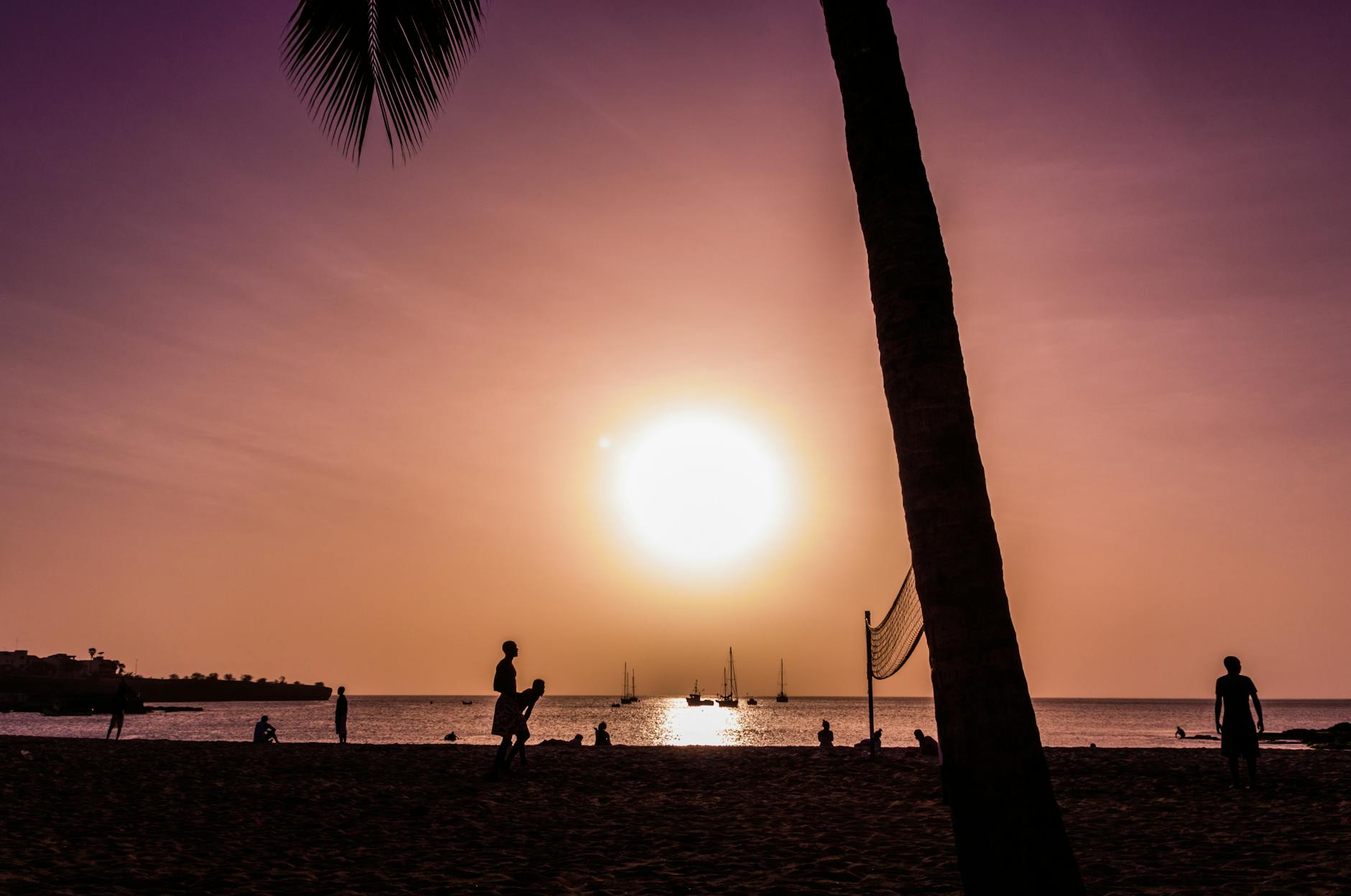silhouette of people on the beach during sunset