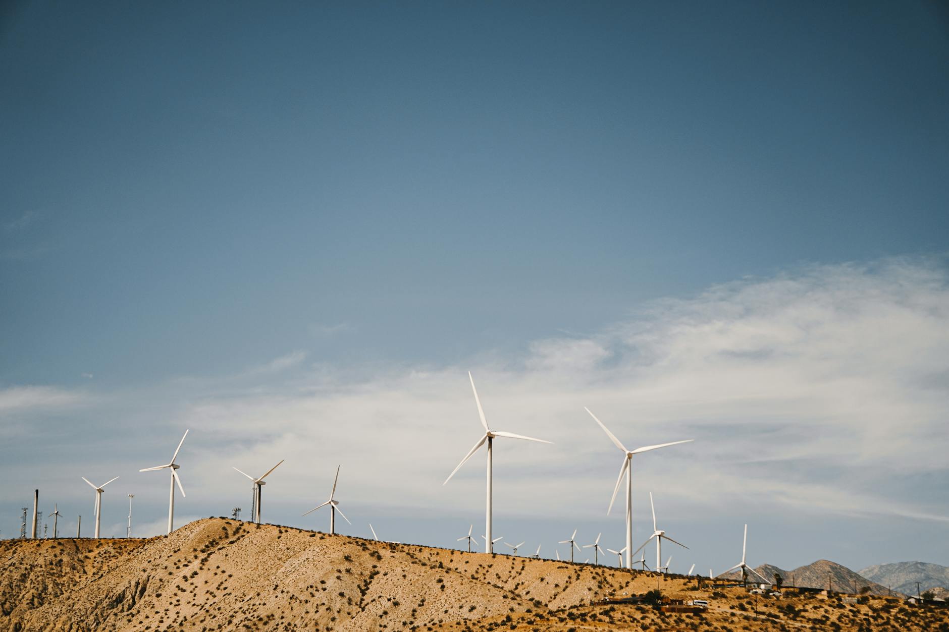 a wind farm under the blue sky