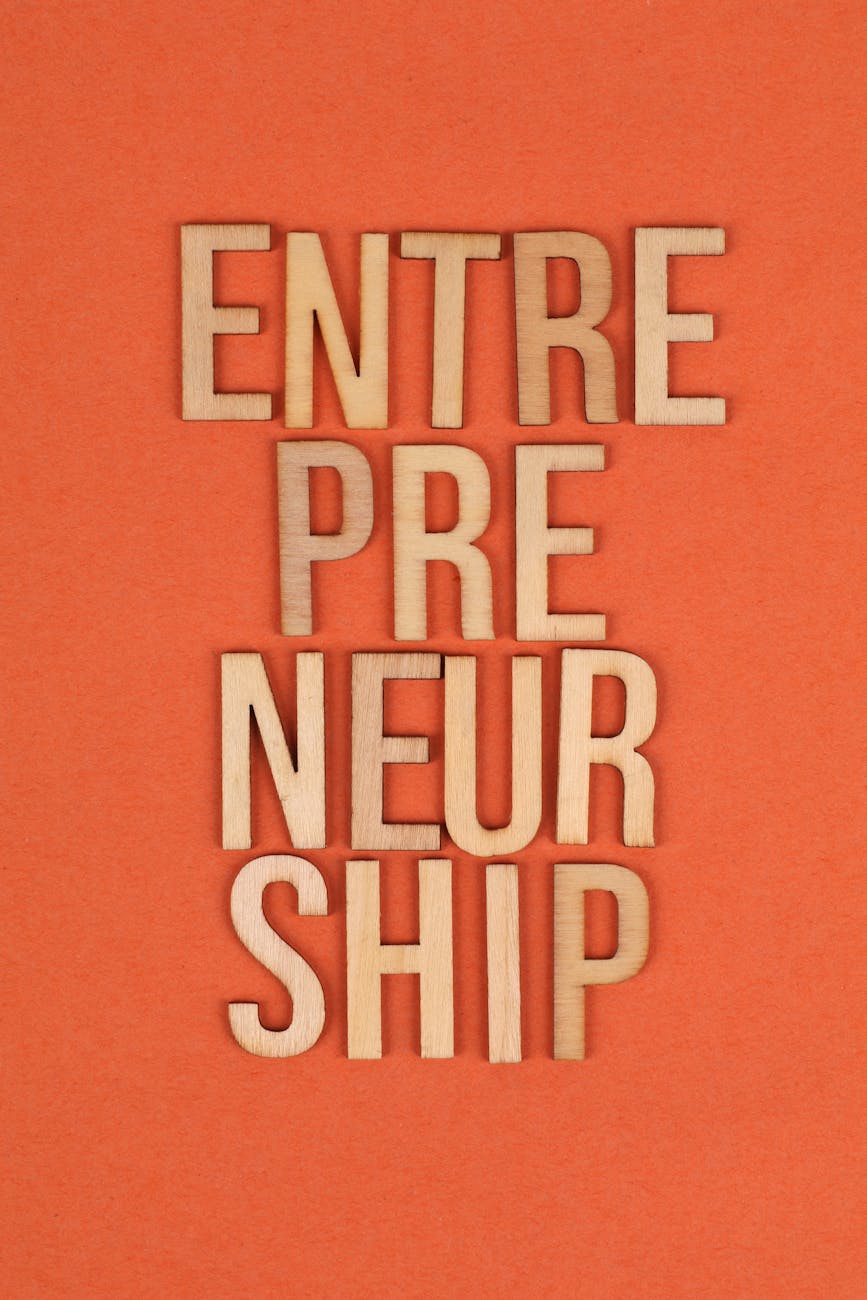 a sign entrepreneurship on orange background