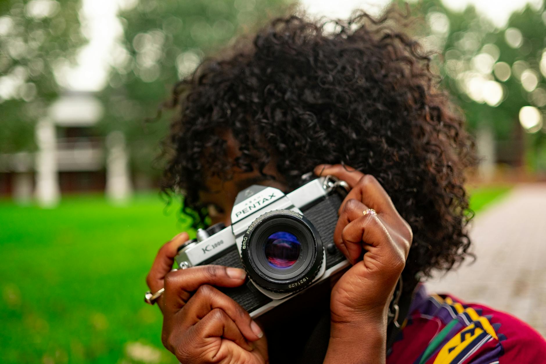 selective focus photography of woman holding camera