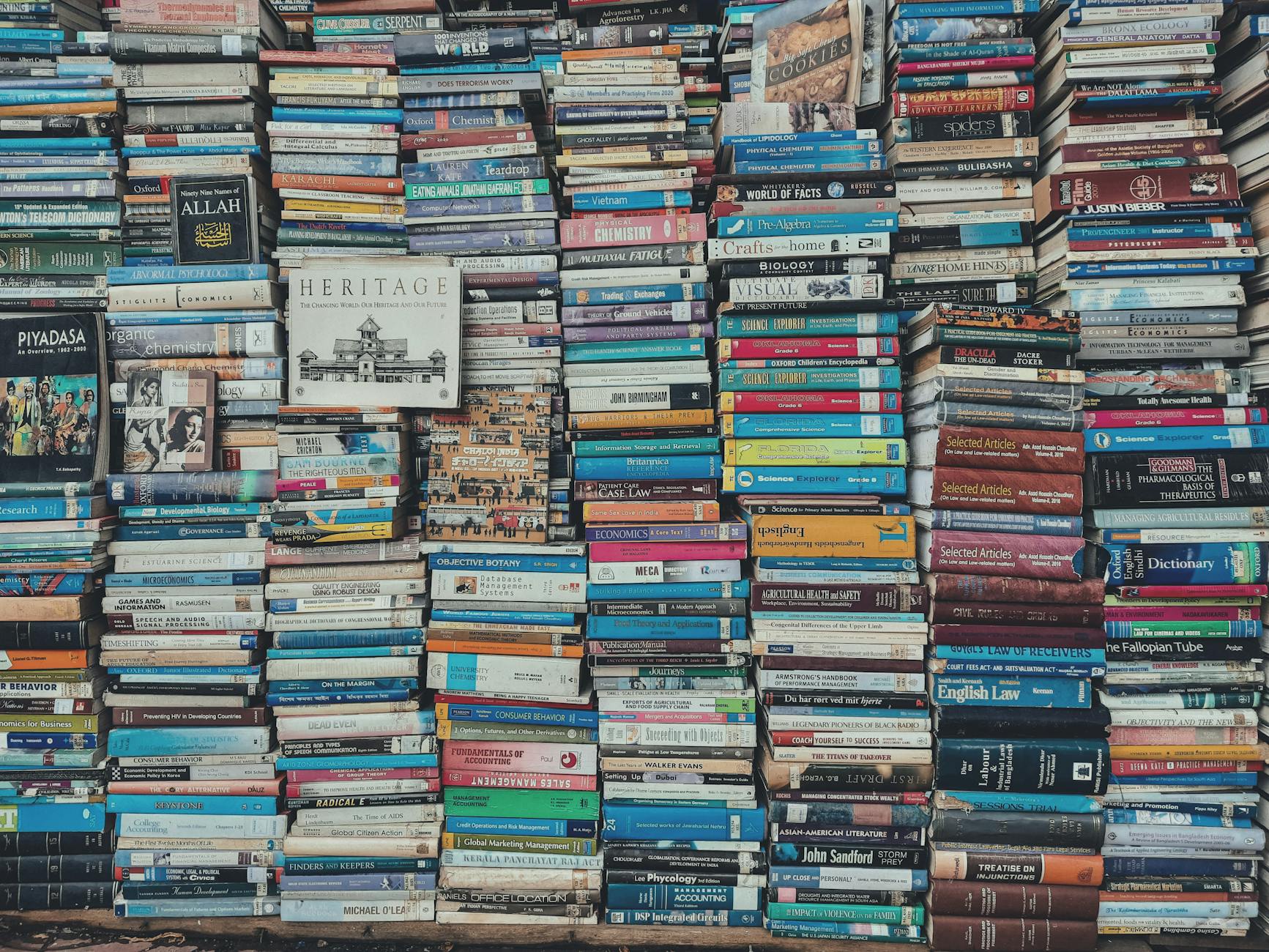 stack of books on wooden shelf