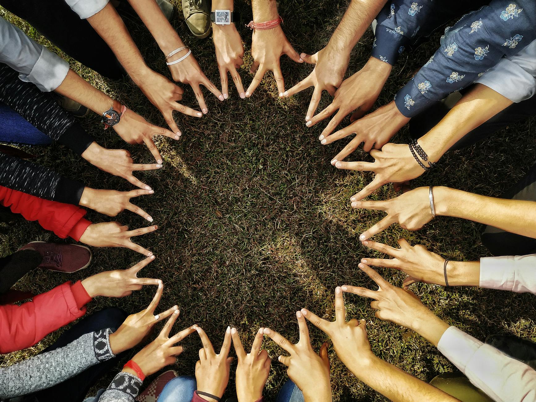 people hands showing peace signs