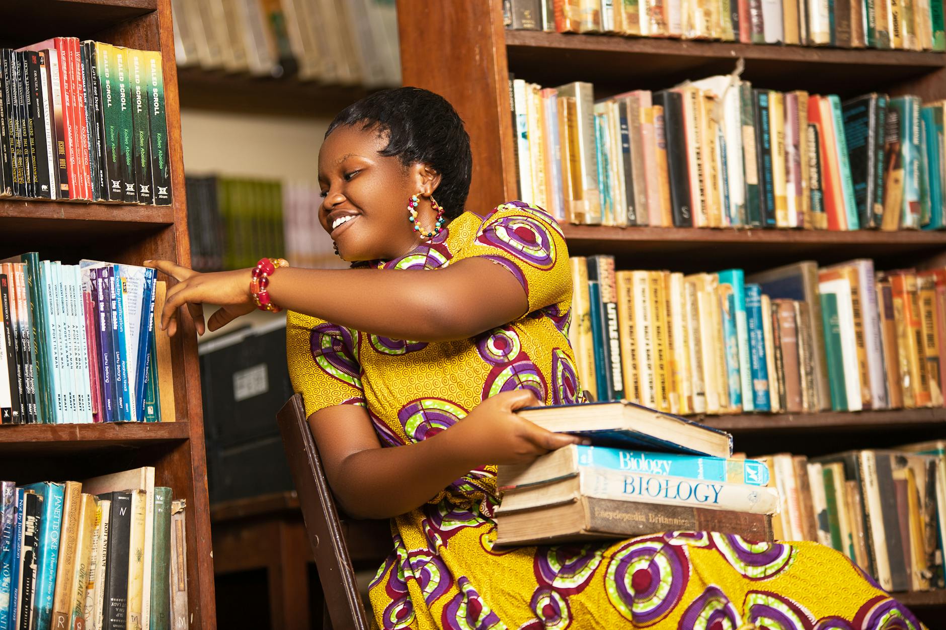 african woman reading books in ghana library