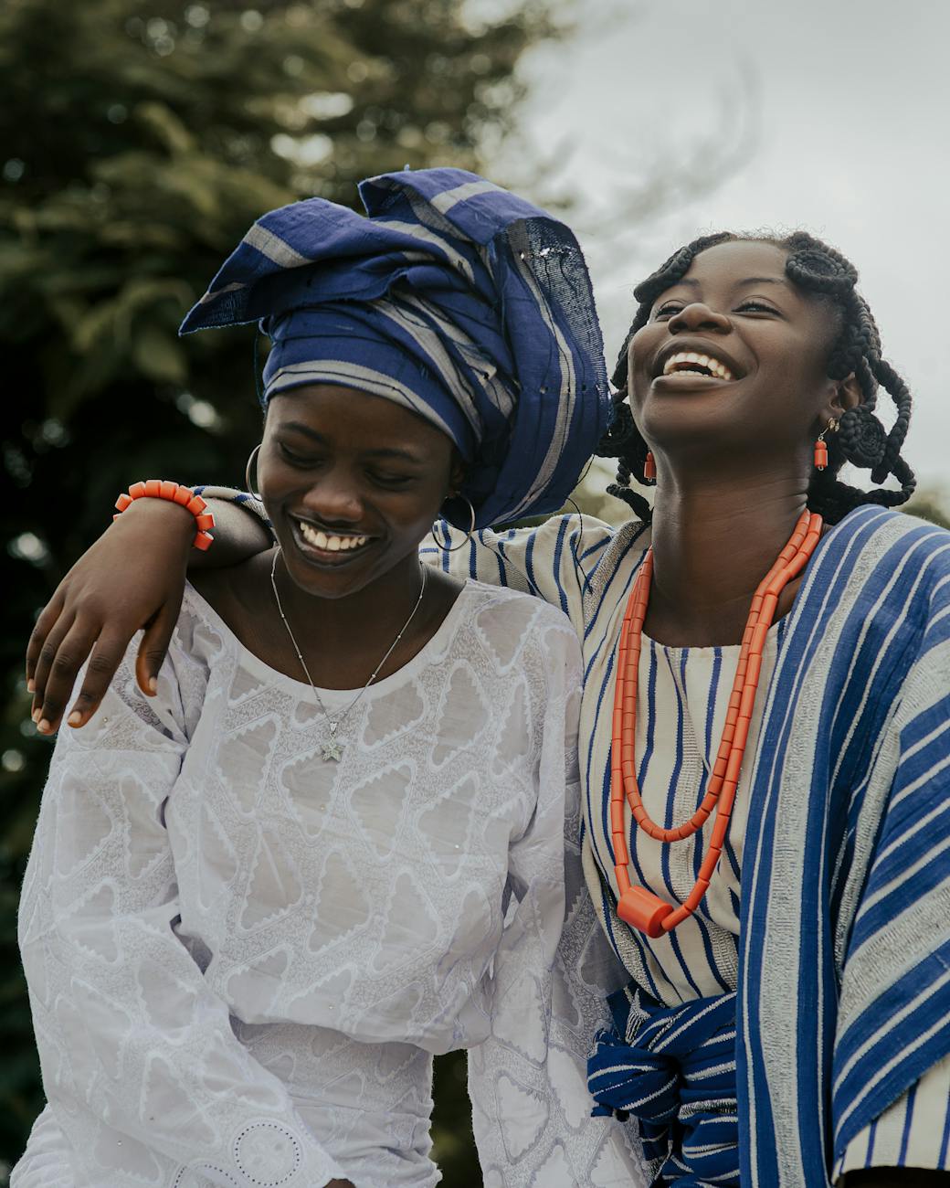 joyful african women in traditional attire outdoors