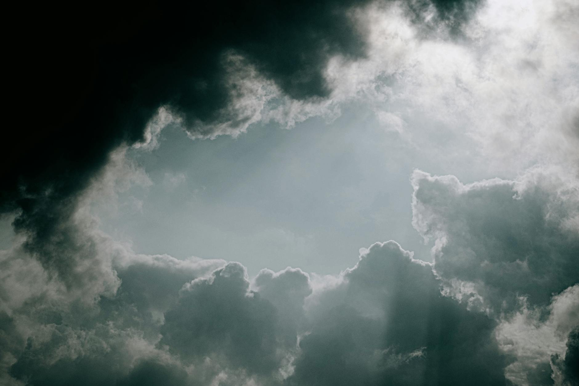 dramatic cloudy sky with sunlight peeking through