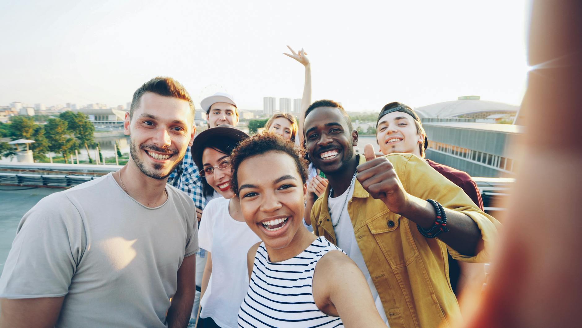 group of friends taking a rooftop selfie