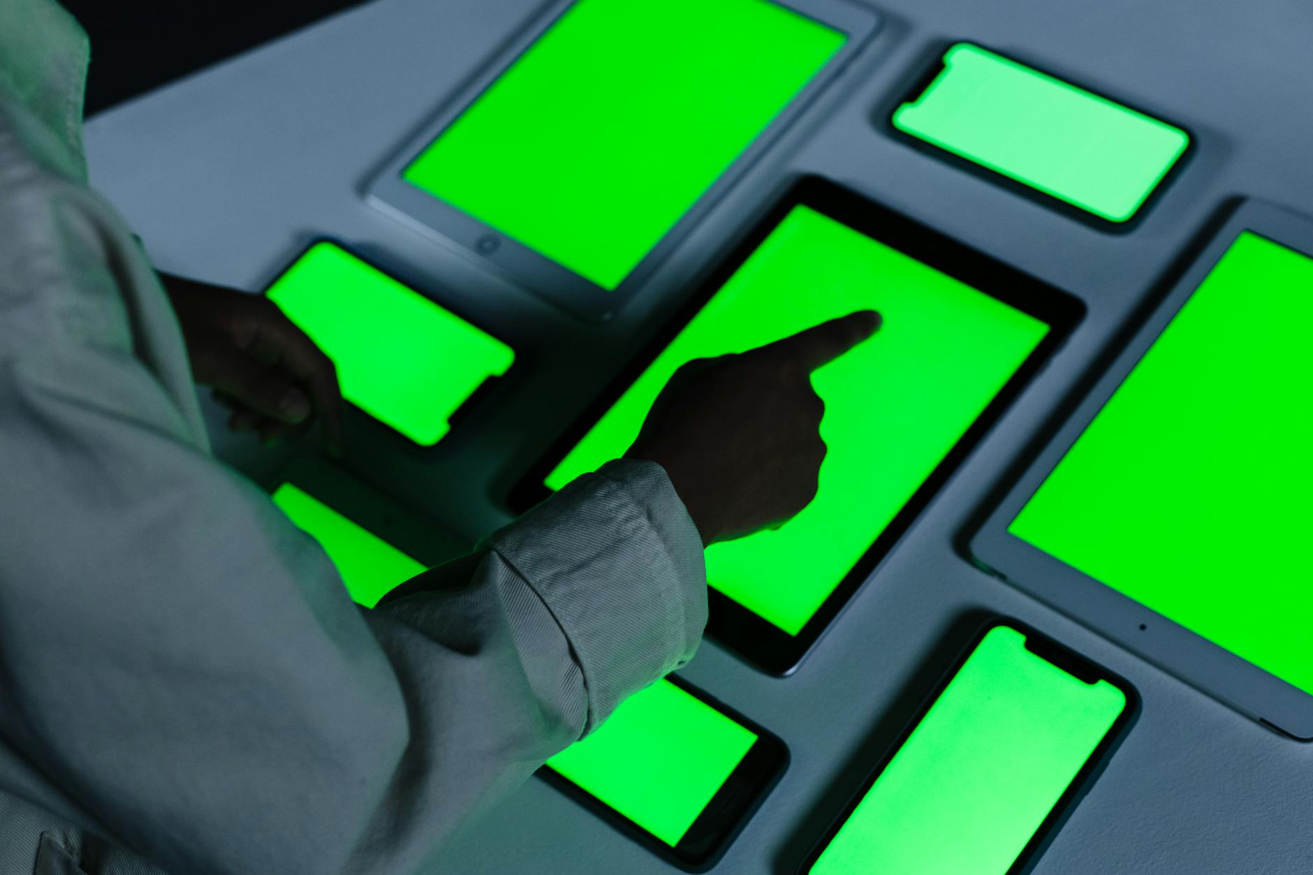 human hand touching tablet with green screen