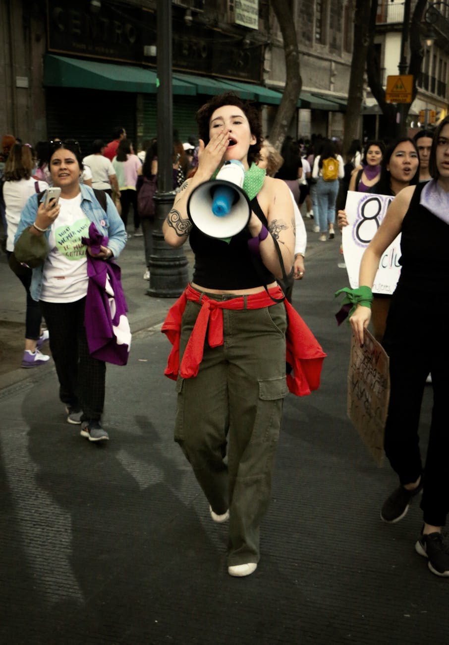 women walking in a protest on a street in city