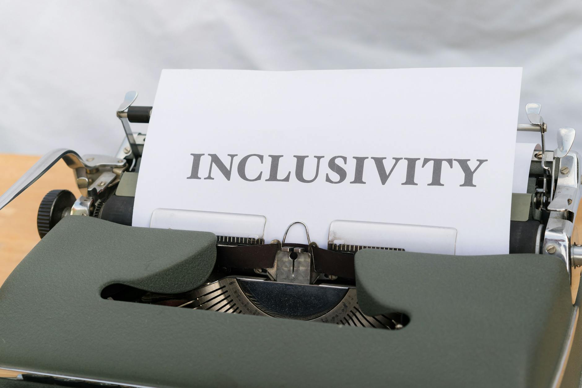 a typewriter with the word inclusivity on it