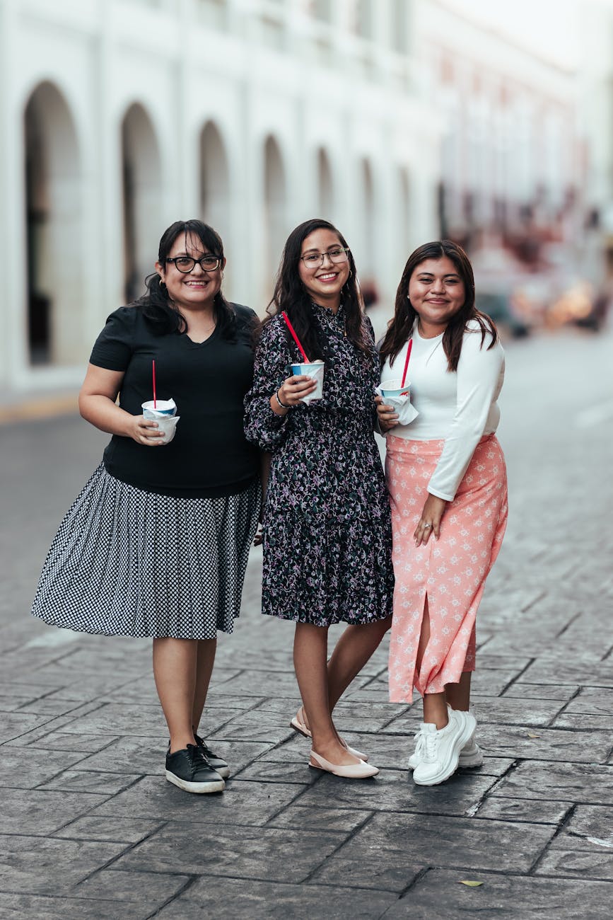 three women posing on the street