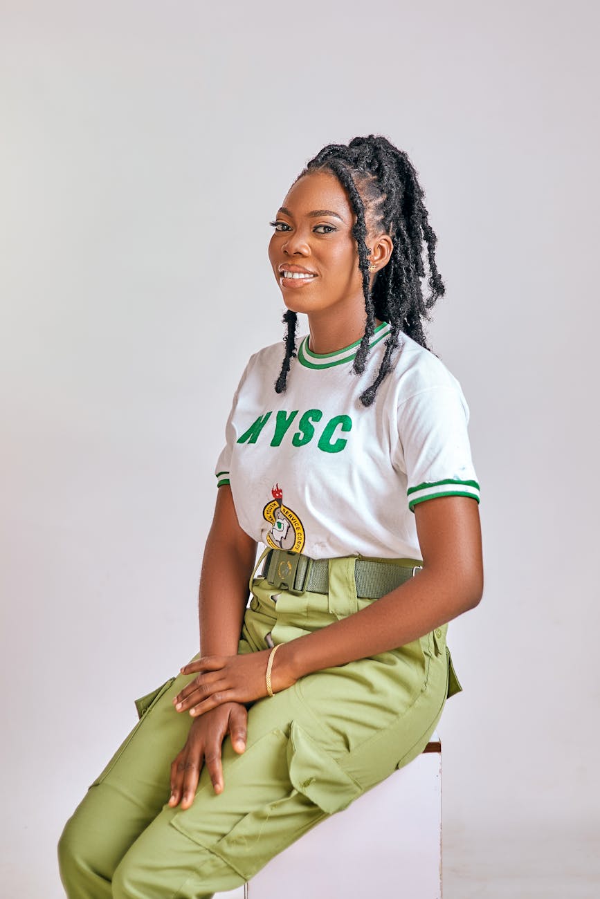 young woman in nysc uniform smiling