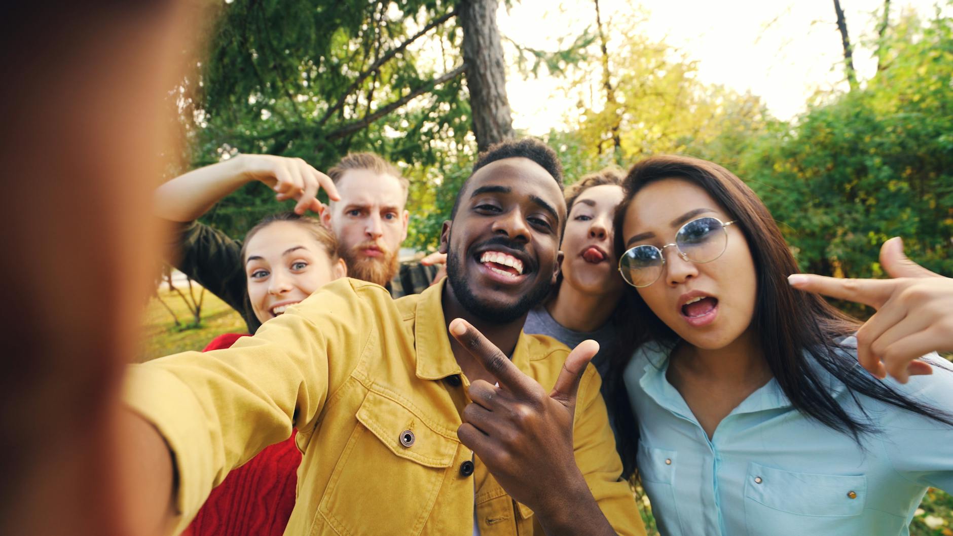 happy friends taking a fun selfie outdoors