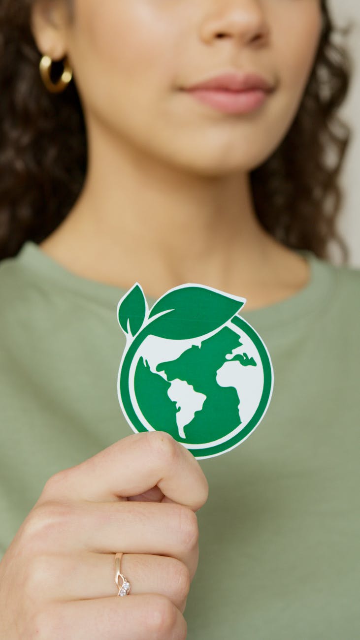 a woman holding a greenpeace logo