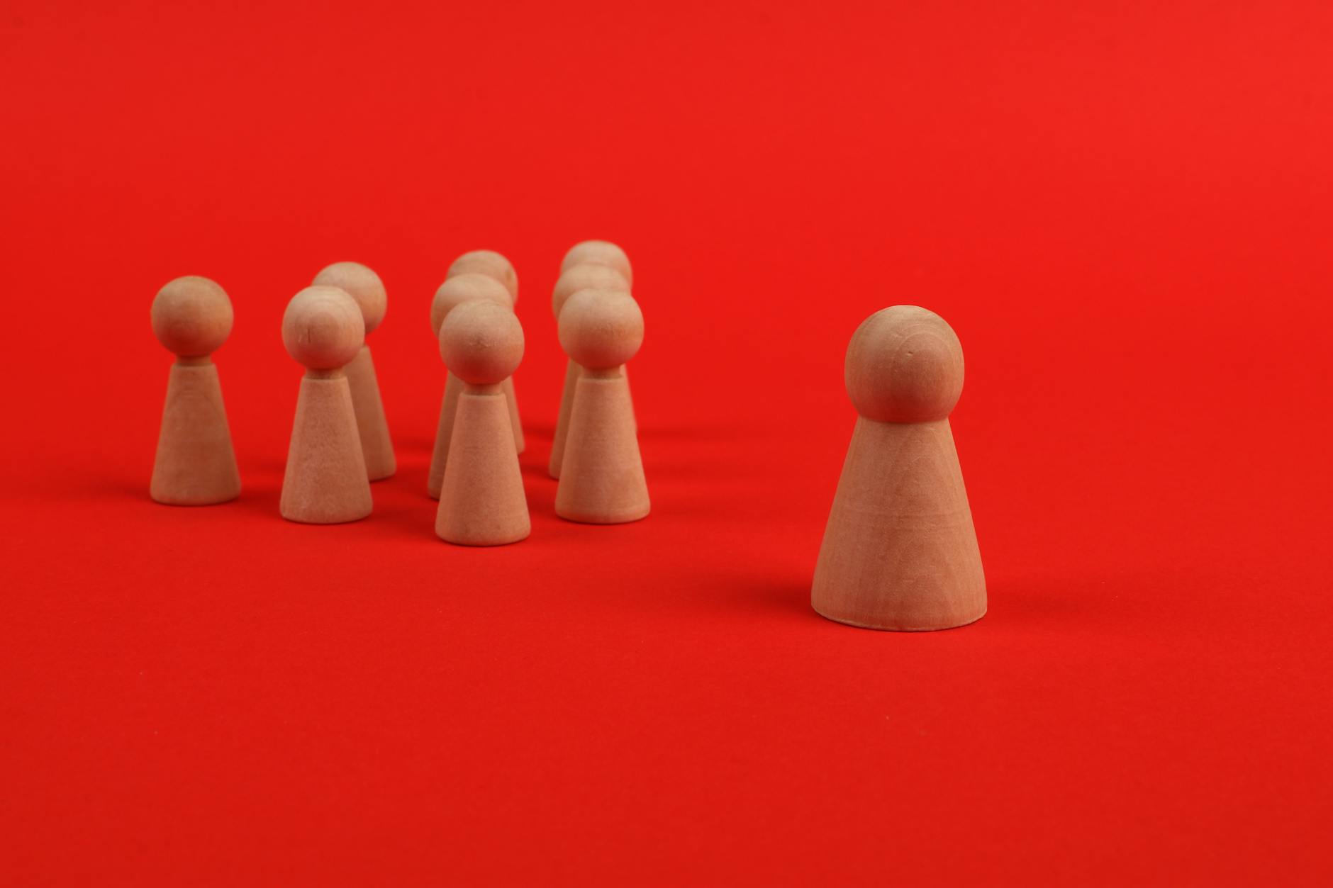 wooden figures on the red background
