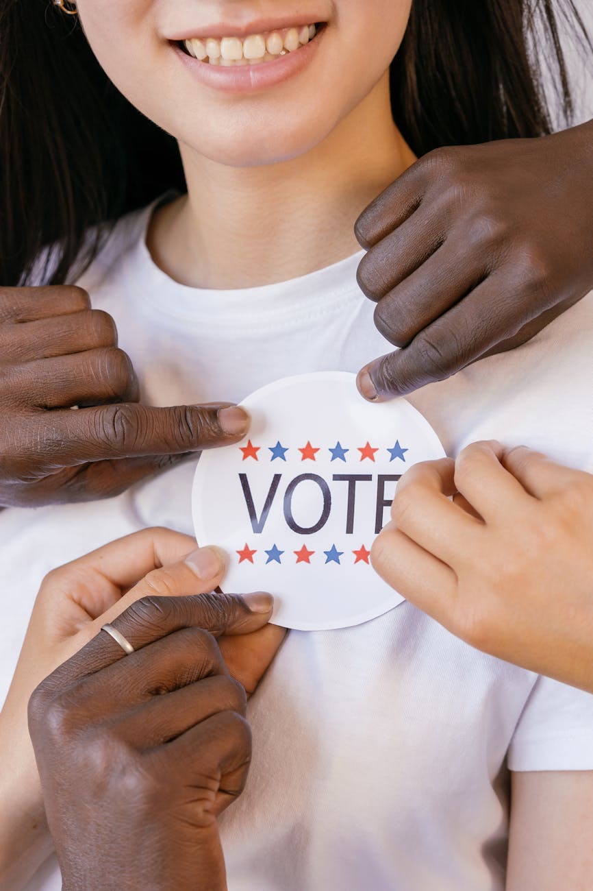 close up photo of voter s badge held by hands