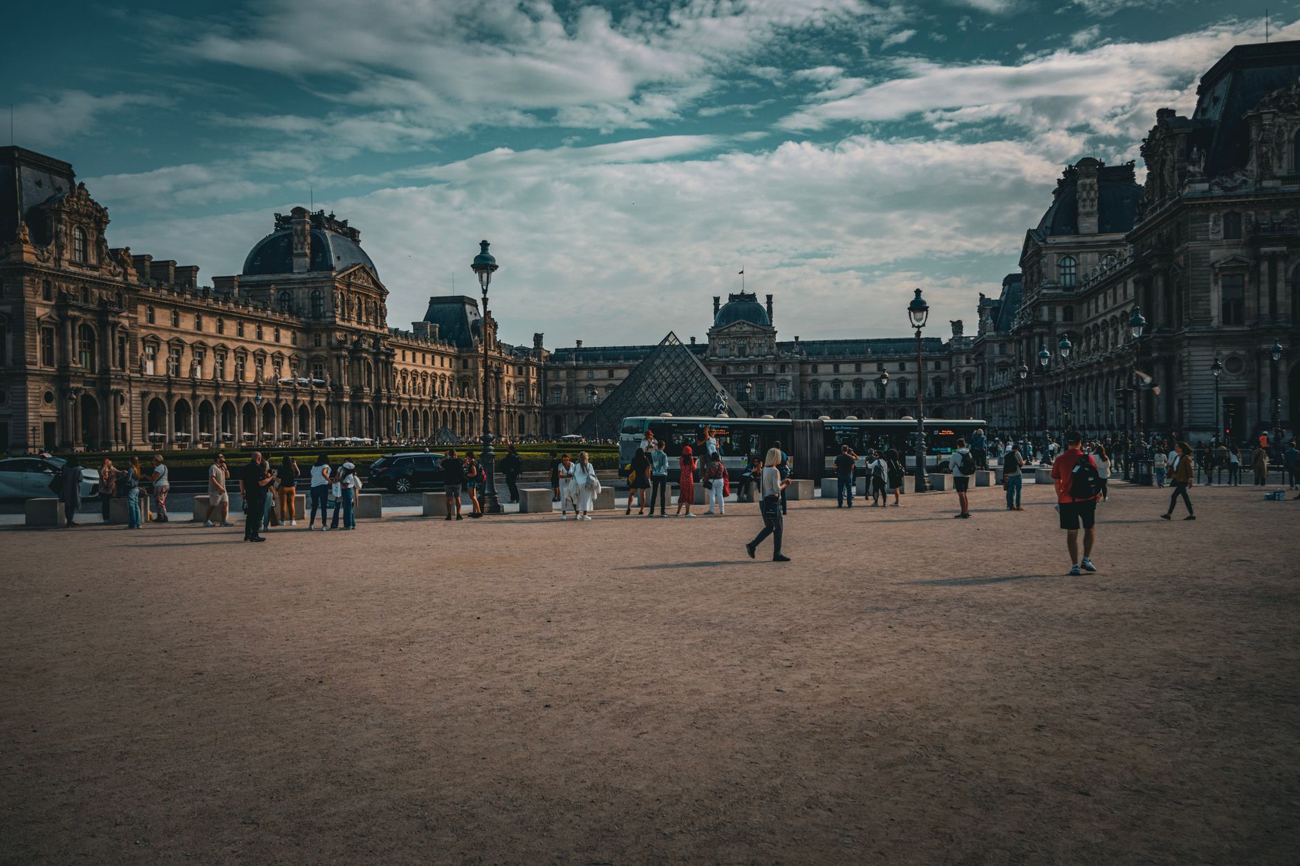 people walking on square near louvre museum