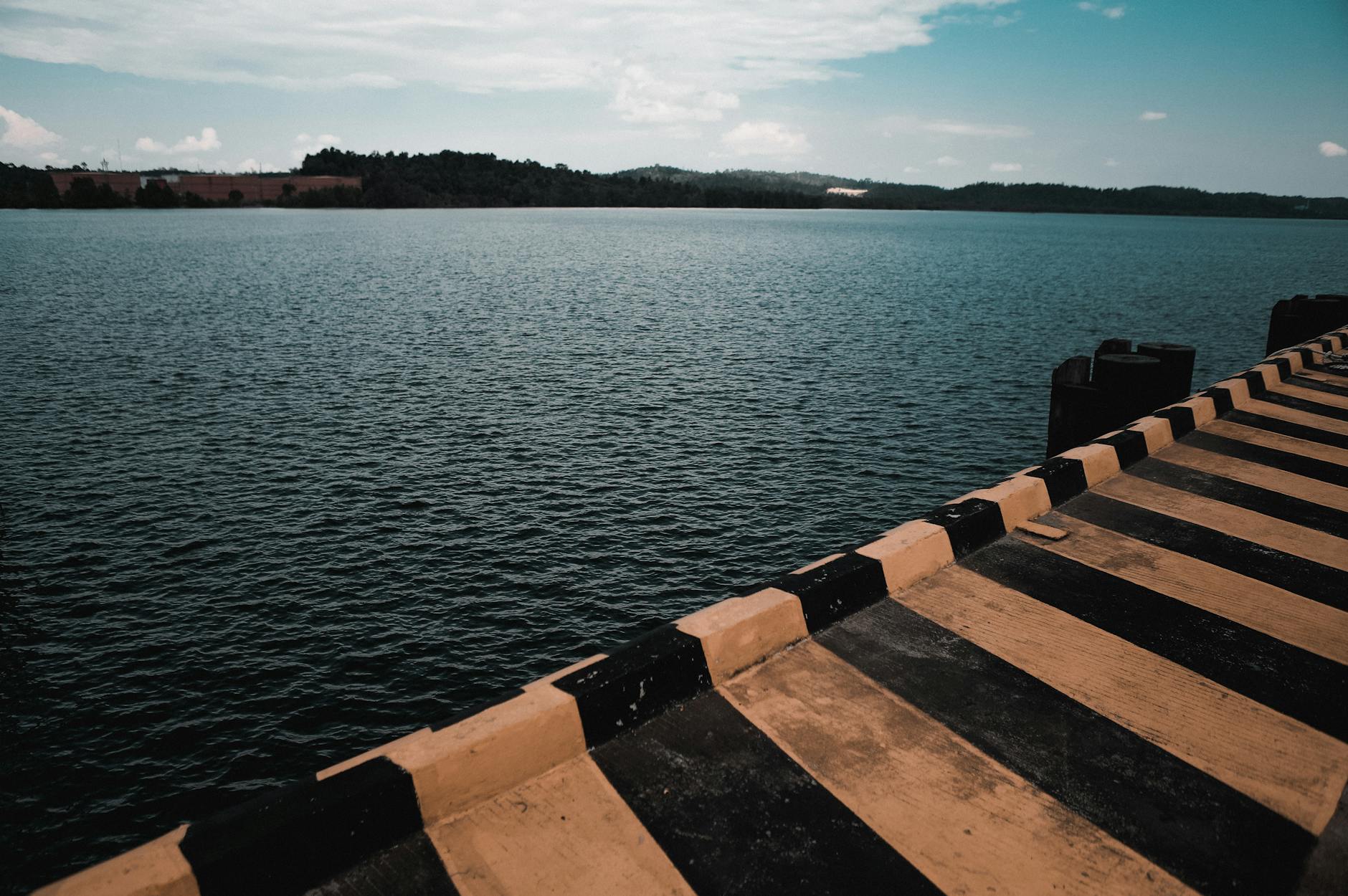 black and yellow dock near body of water