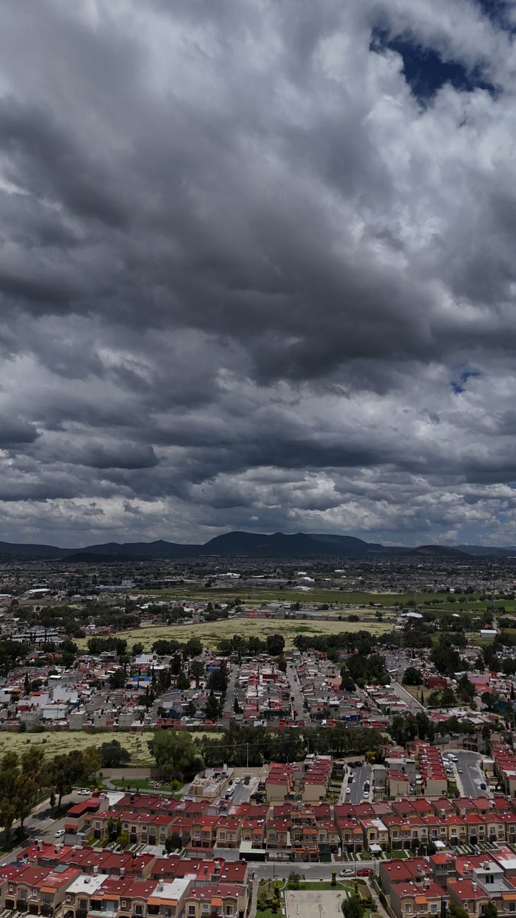 aerial view of cloudy skies over mexican cityscape