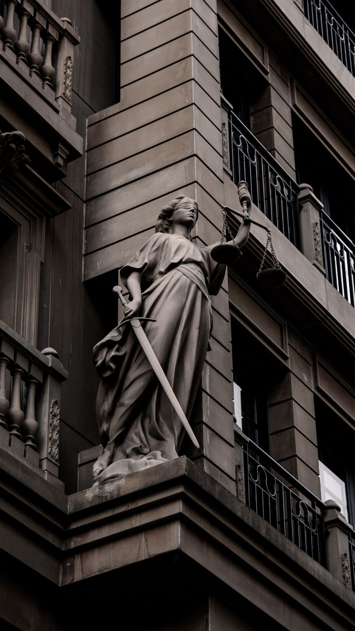 justice statue on urban building facade