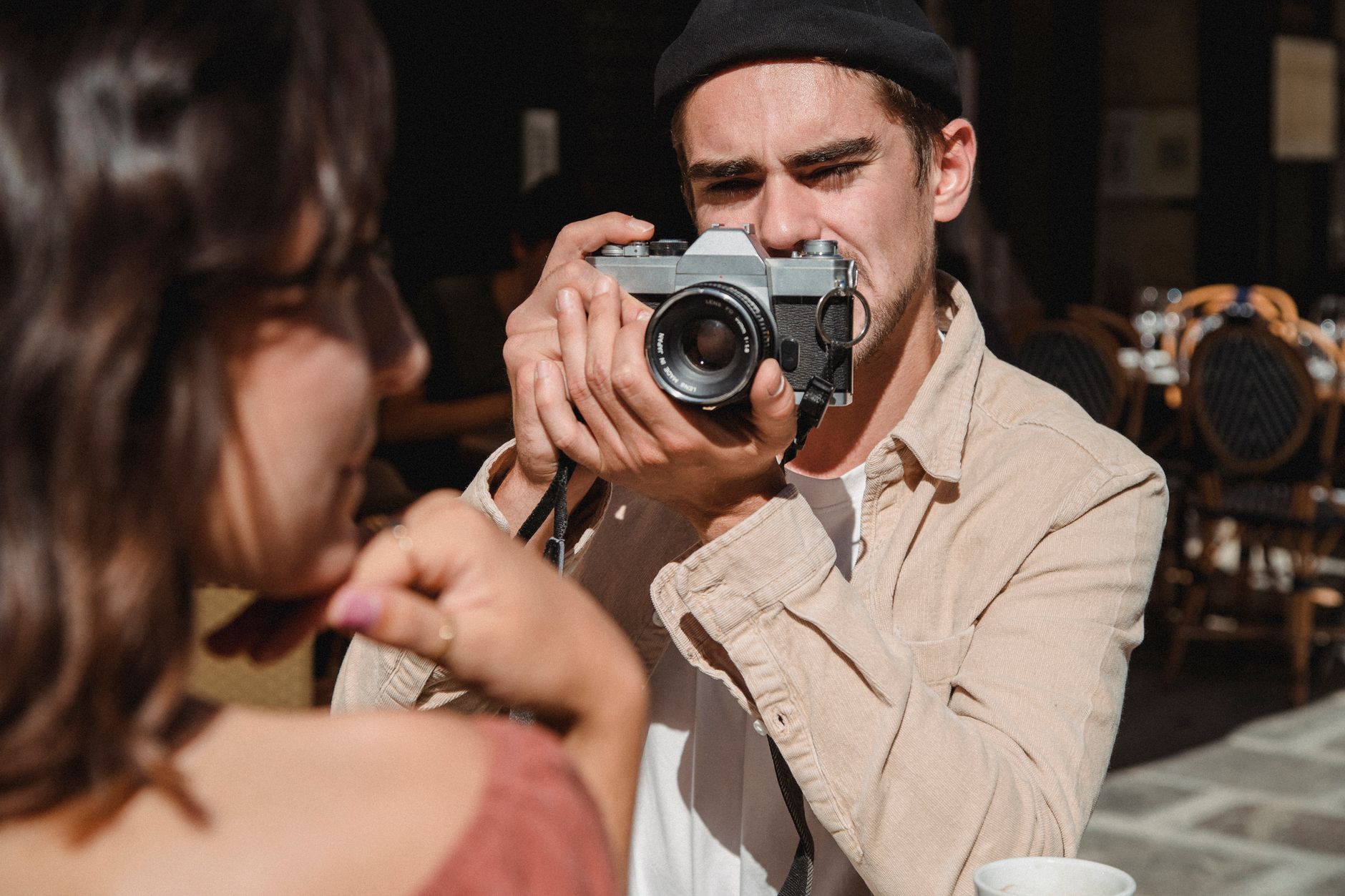 man in beige button up shirt holding black camera