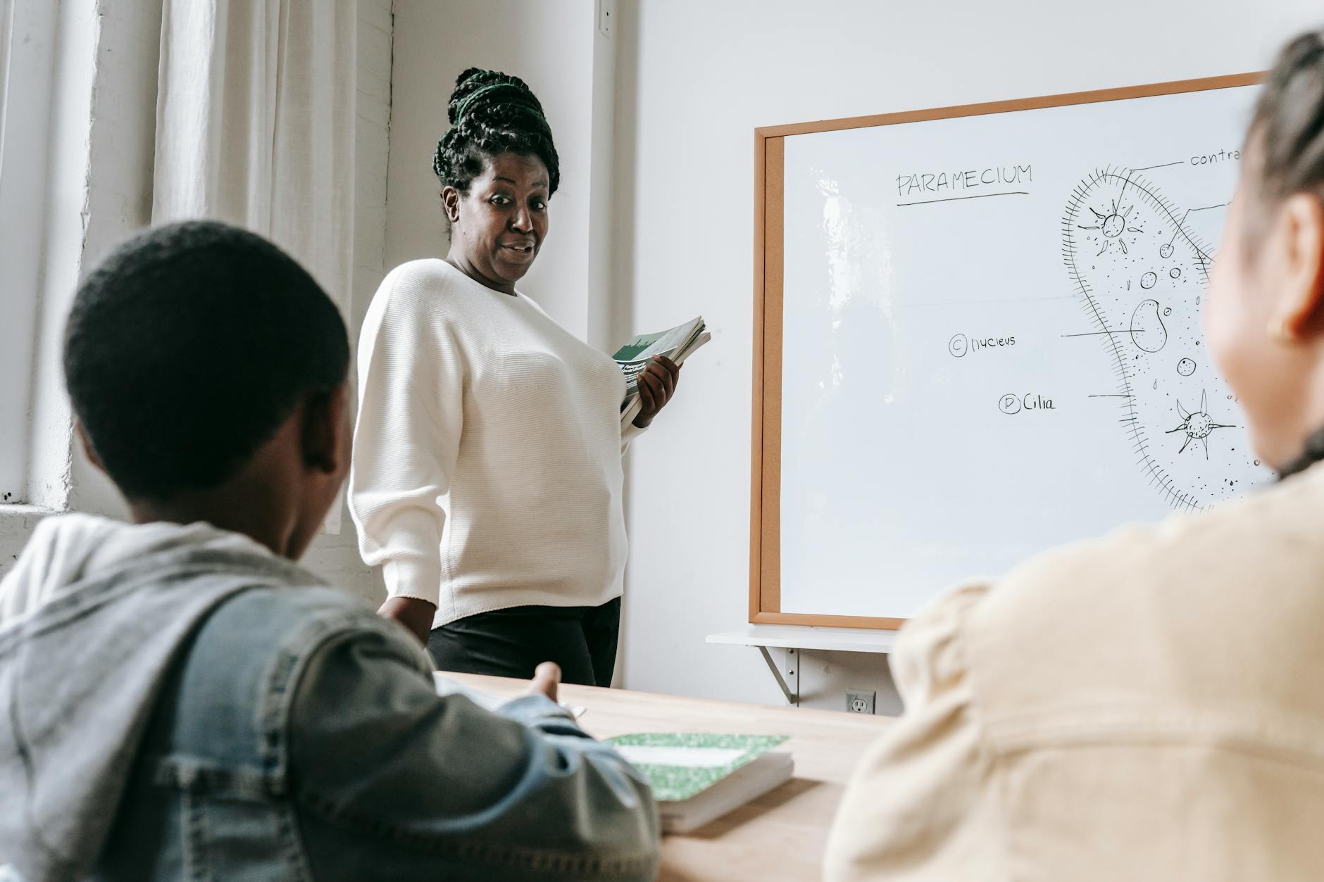 black woman with students on lesson