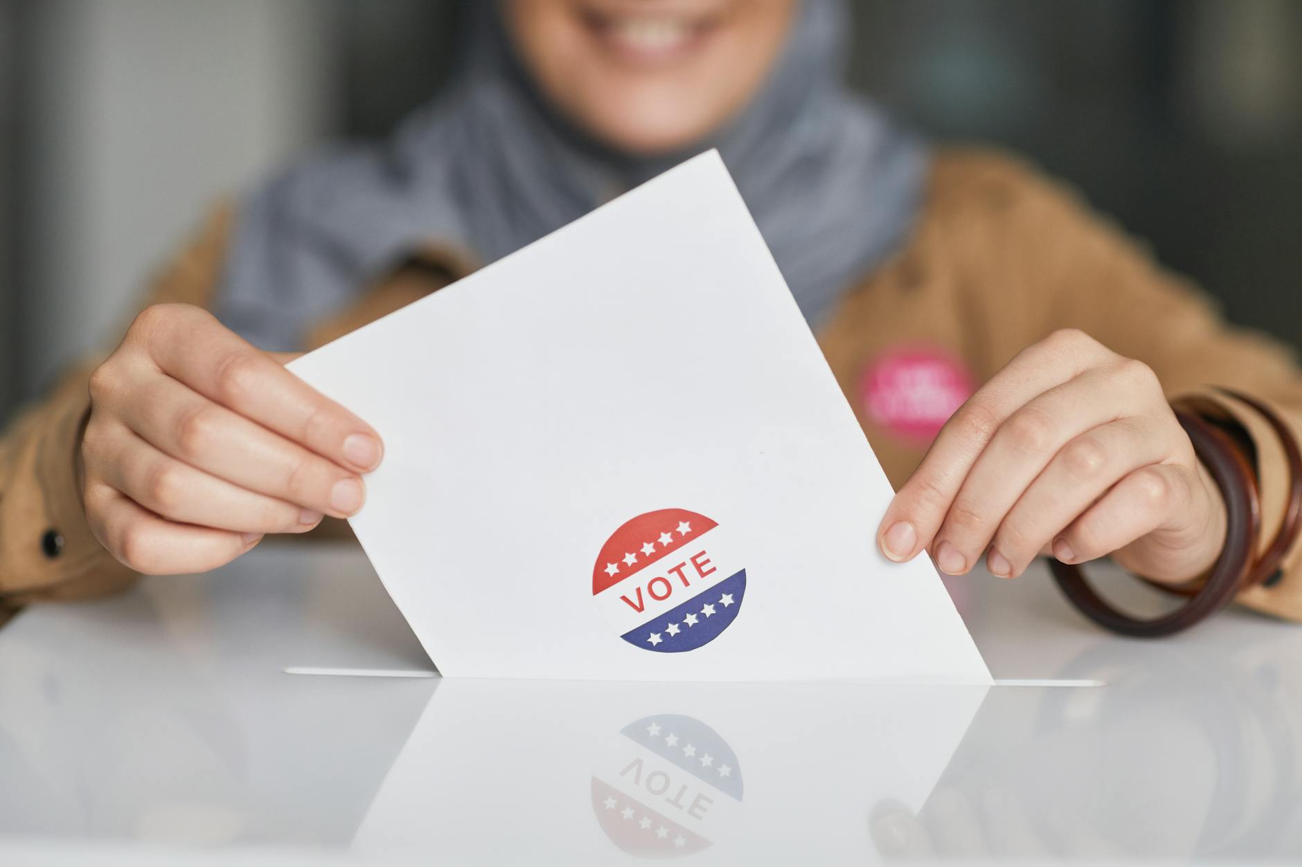 a woman dropping her vote in a box