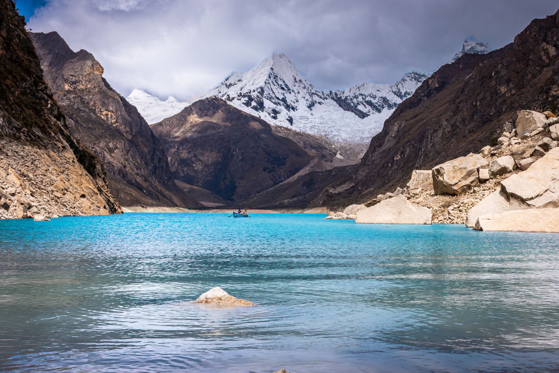 Breathtaking view of turquoise waters and snow-capped peaks in Huaraz, Peru's Cordillera Blanca.