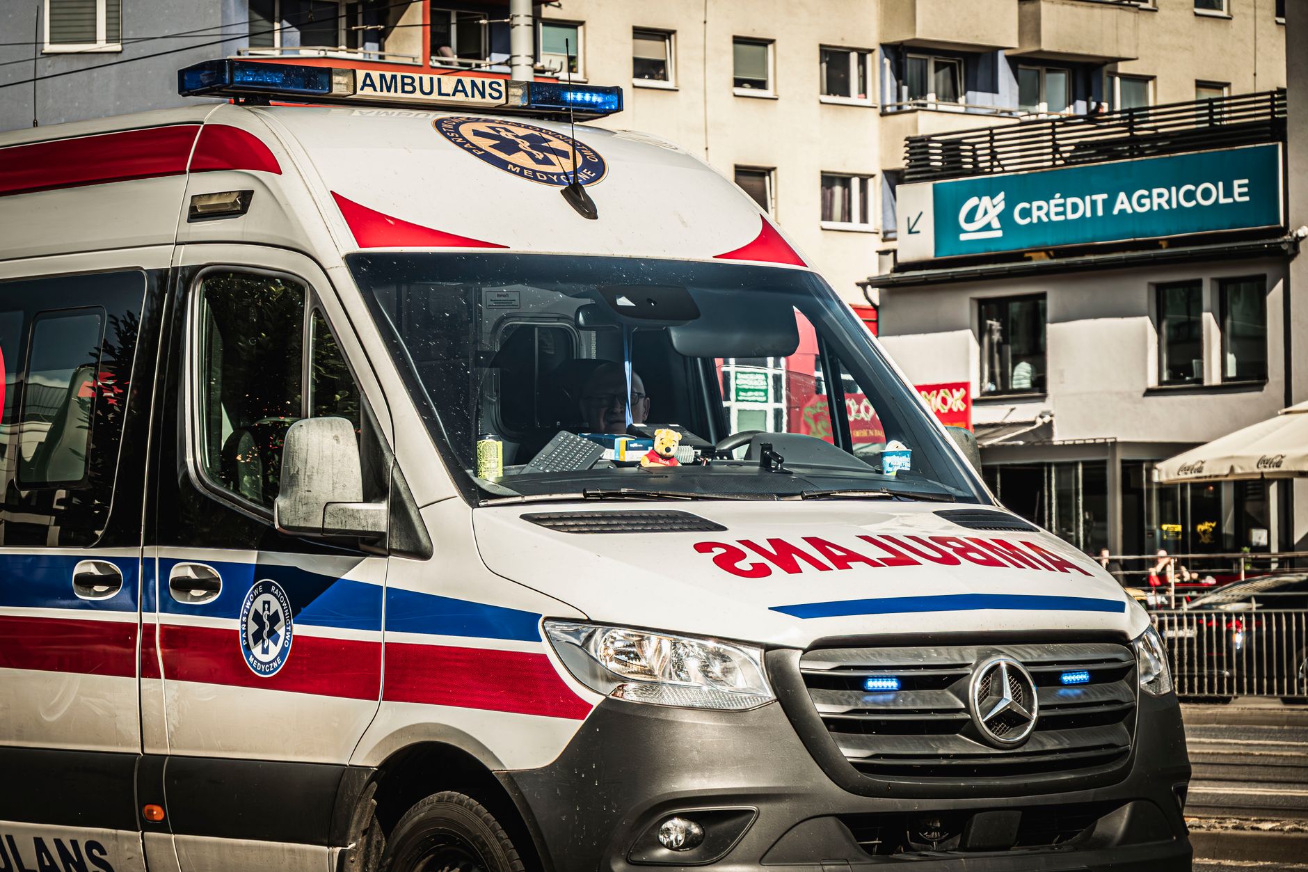 View of a modern ambulance on a city street in Wrocław, Poland.