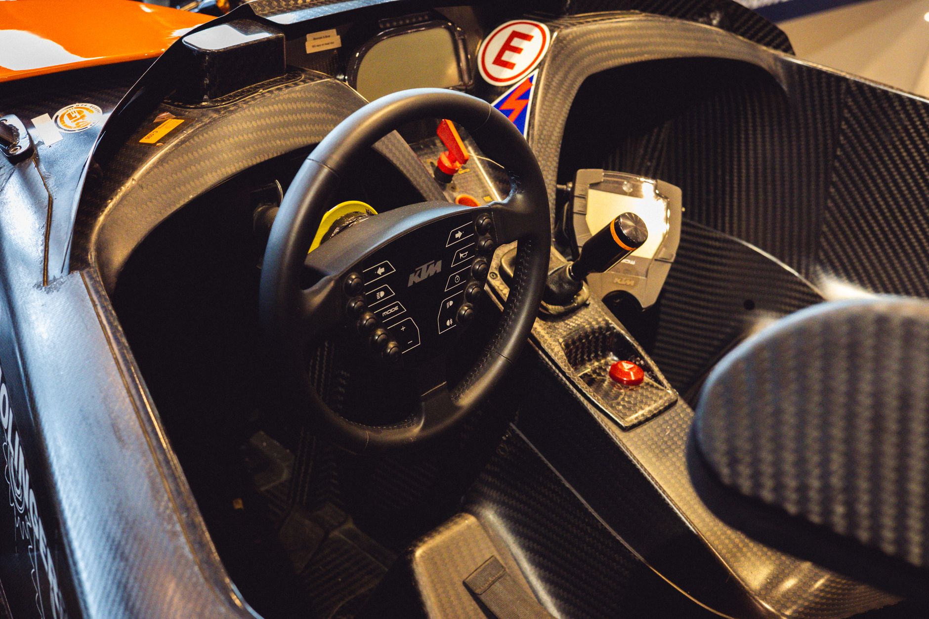 Detailed view of a high-performance race car interior showcasing the steering wheel and controls.