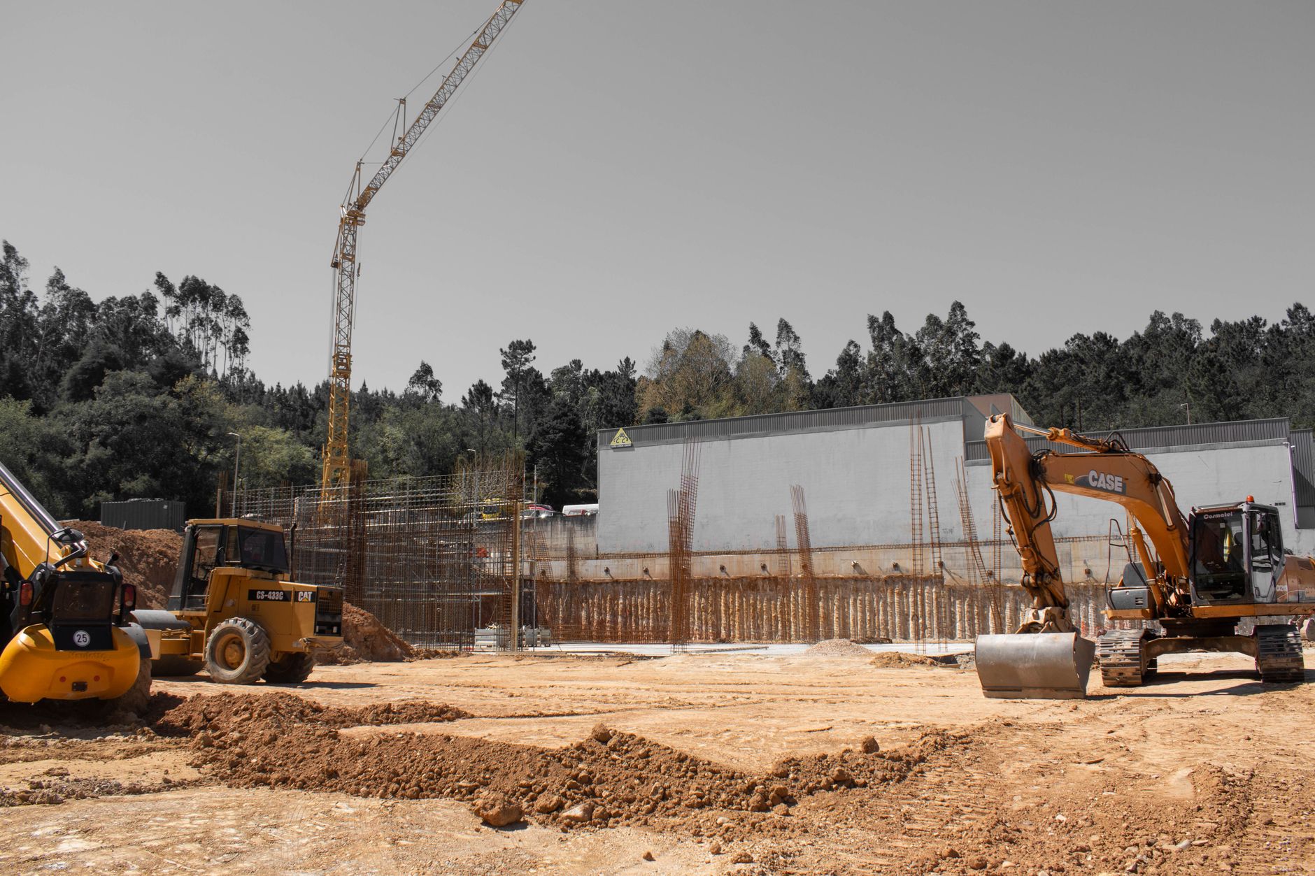 A busy construction site with cranes and heavy machinery for building infrastructure.