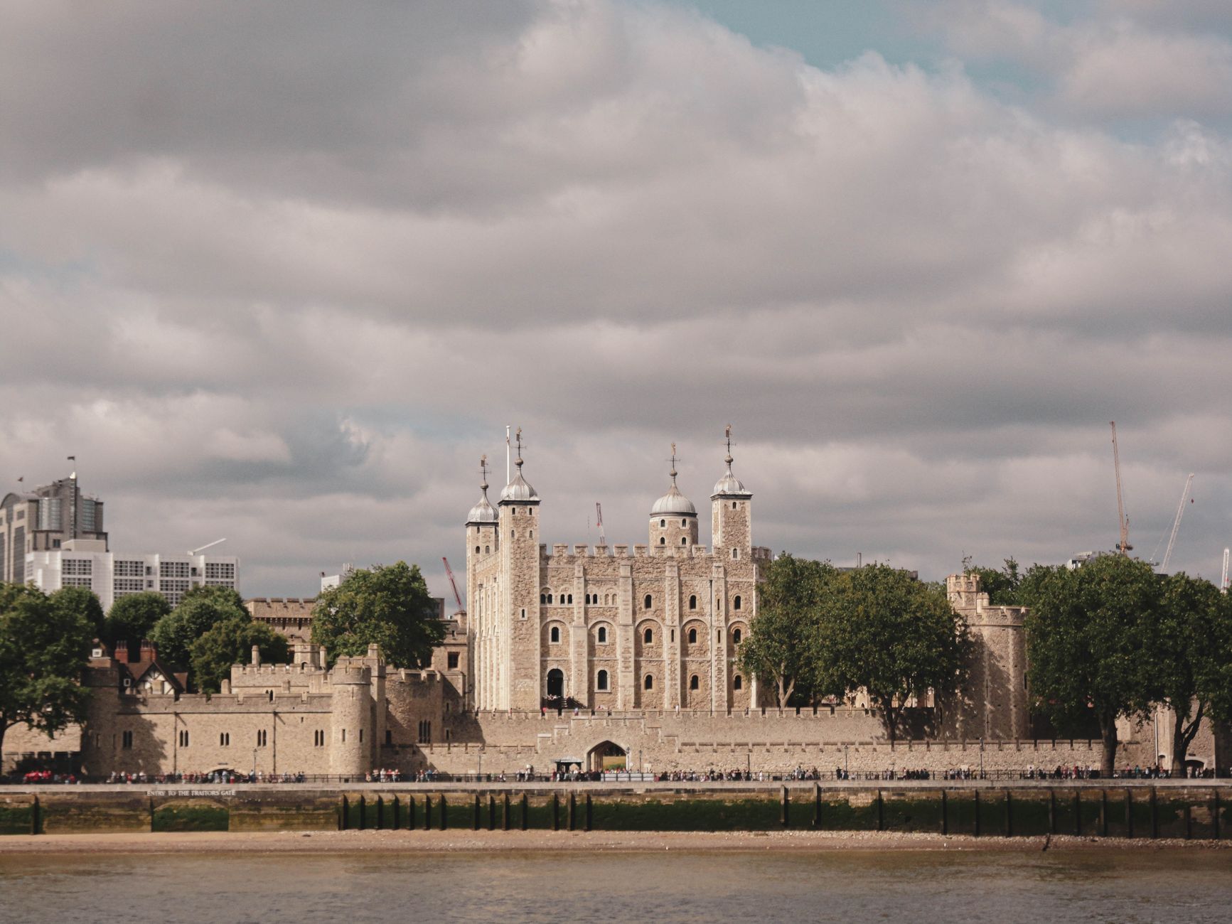 The Tower of London captured in daylight, highlighting its historic architecture along the Thames River.