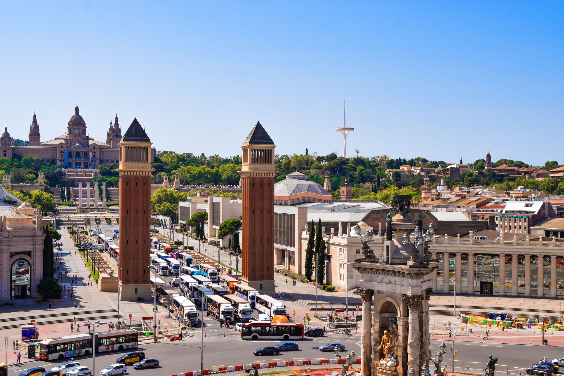A vibrant aerial shot of Placa d'Espanya in Barcelona featuring iconic architecture and bustling city life.