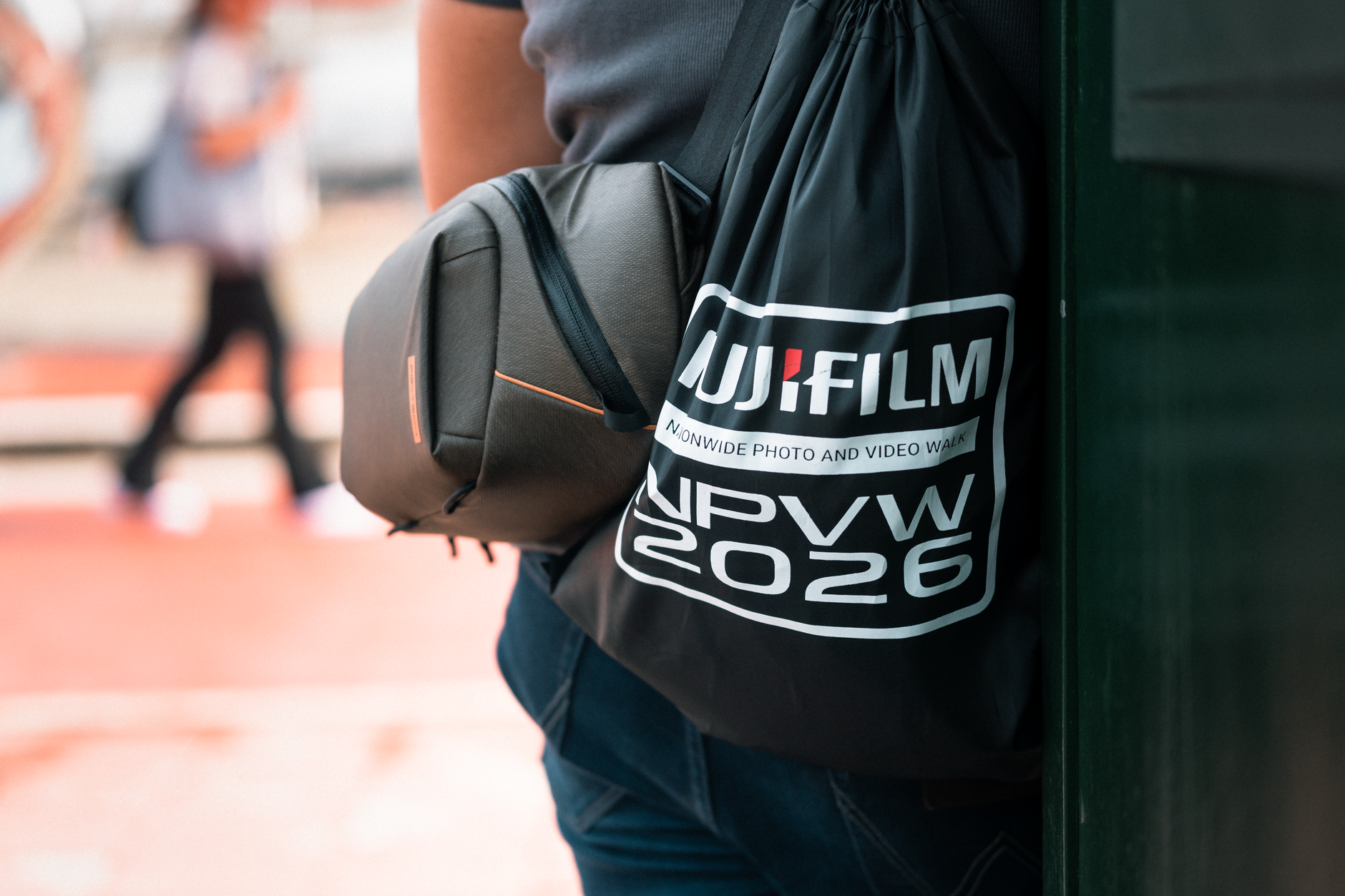 Person with camera gear bag on a city street in Manila, Philippines.