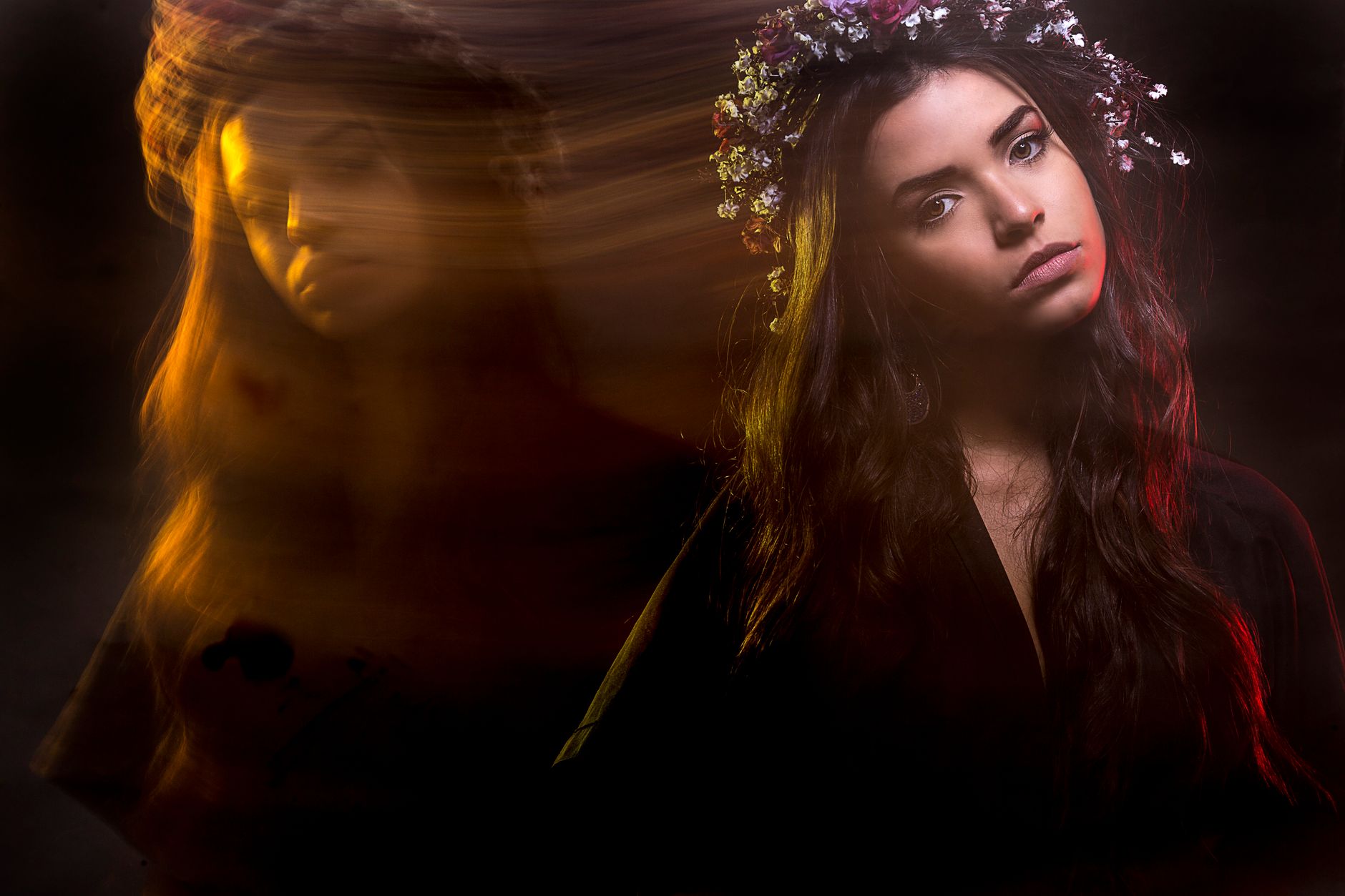 A creative portrait of a woman using long exposure, capturing artistic motion and ambient light.