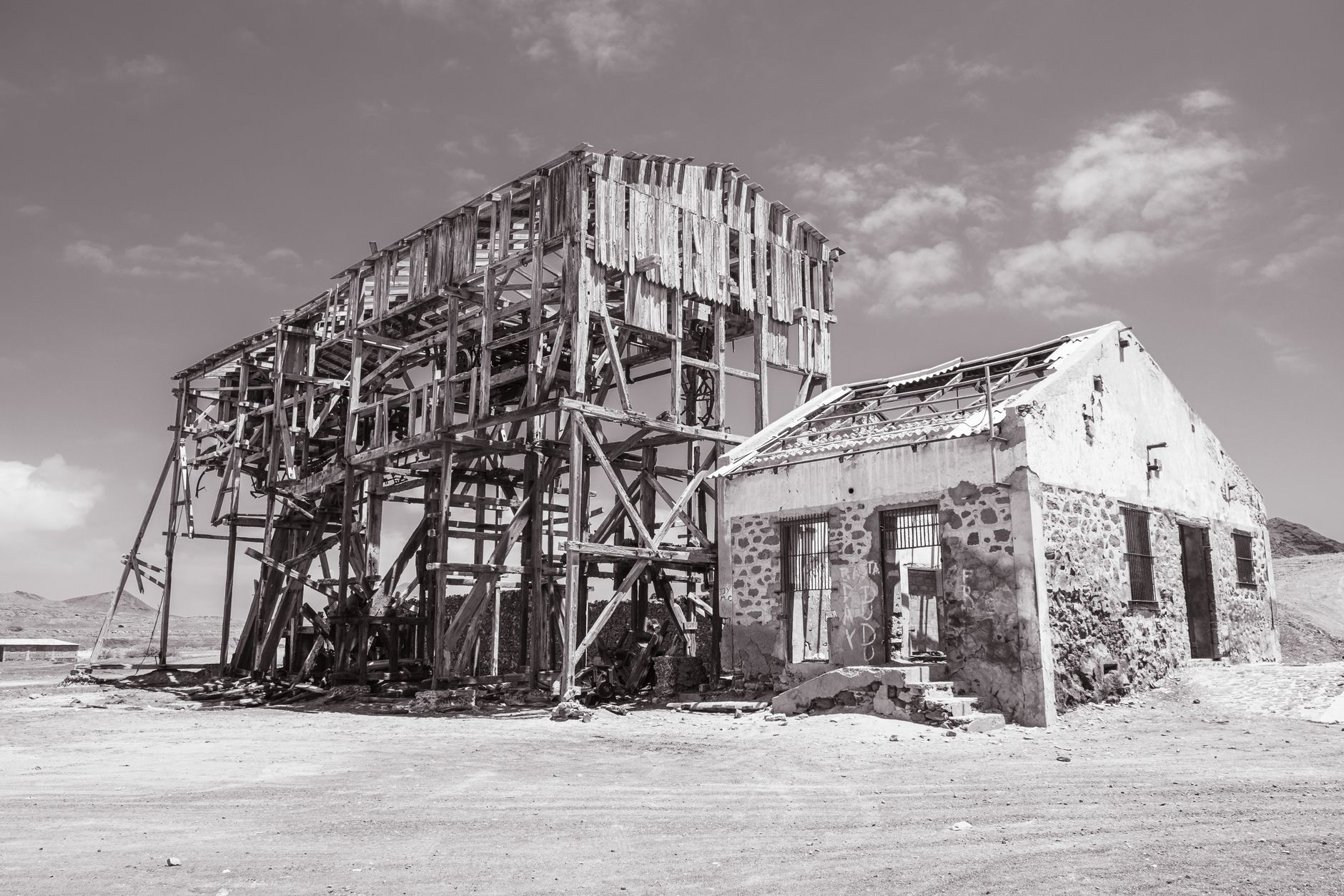 Desolate abandoned buildings in Pedra Lume, Sal, Cabo Verde, under a bright sky.